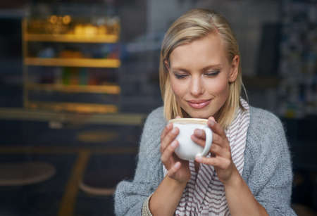 We all need somewhere to go to be alone. A young woman sitting in a coffee shop.