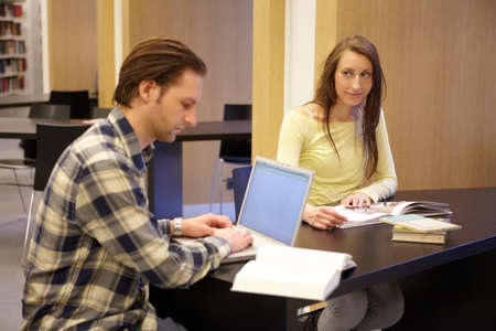 Hes my inspiration. Shot of a young man and woman studying together.