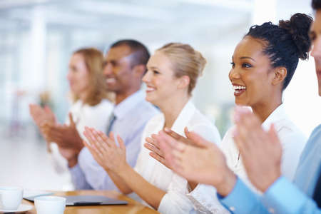 Business people applauding. Portrait of multi ethnic business people applauding during presentation.