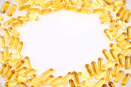Surrounded my medicine. Studio shot of a lot of medical pills scattered against a white background.