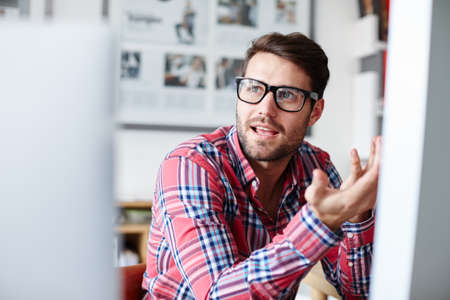 Offering his honest input. Shot of a young designer explaining something to a colleague.