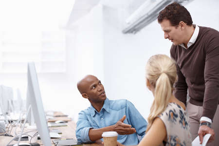 Is there anything youd like to add. Two colleagues talking to their boss while working hard in the...