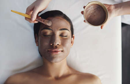 Cleanse your skin from deeper within. Shot of a young woman getting a facial treatment at a spa.の写真素材