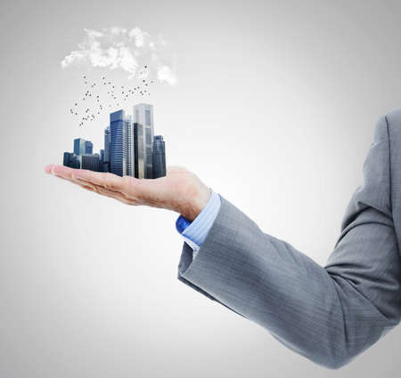The whole city in the palm of your hand. Cropped studio shot of a businessmans arm holding a...