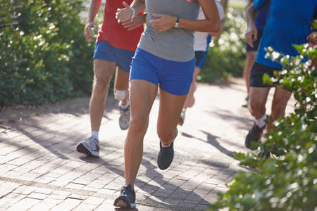 Leading the pack. Cropped shot of a group of people running.の写真素材