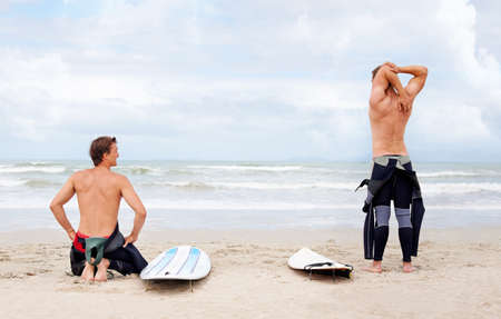 Surfing is a lifestyle. Young surfers enjoying a day out on the beach in the summertime.の写真素材