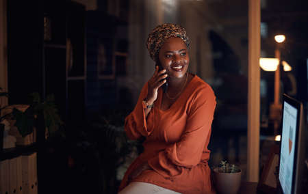 I got the deadline done and will be home soon. Shot of a young businesswoman talking on a cellphone...