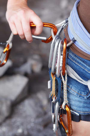 Attaching herself to the rope. A rock climbers hook with an assortment of clips attached to it.の写真素材