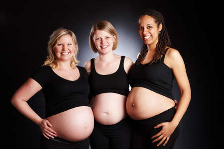 Life long friends sharing the same experience. Portrait of three pregnant women smiling for the...