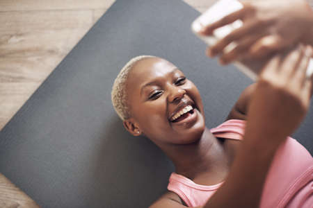 I have to get a selfie for my social media. Cropped shot of an attractive young woman using her...