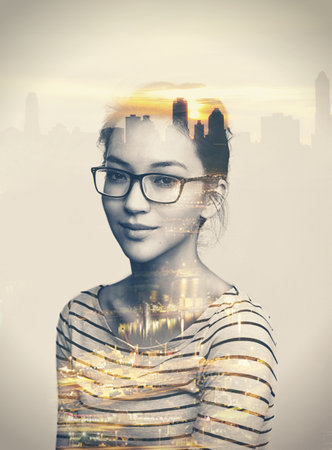 Shes a city kinda girl. Multiple exposure portrait of a young woman superimposed over a city.の写真素材