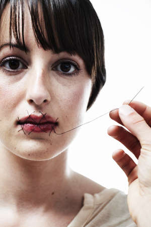 She can no longer speak up. A young woman having her mouth sewn shut.