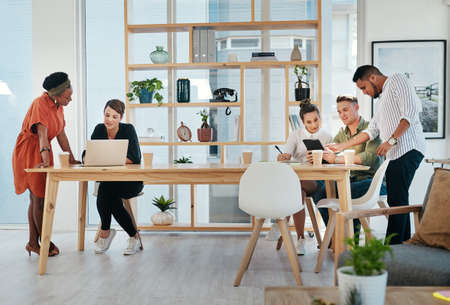 This team run the business. Full length shot of a diverse group of business colleagues working on...