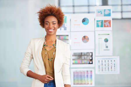 Another successful project in the bag. Portrait of a successful young businesswoman in an office.の写真素材