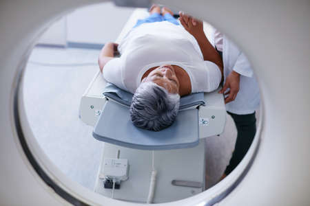 Preparing for the scan. Shot of a senior woman being comforted by a doctor before and MRI scan.