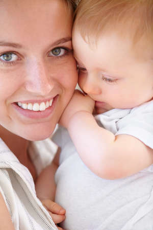 Keeping close to her little man. Closeup shot of a young mother and her adorable son.