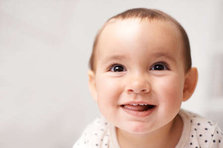 Eyes lit up with curiousity. Cropped shot of an adorable baby girl at home.の写真素材