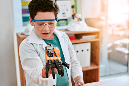Today a toy, tomorrow a real robot. Shot of an adorable little boy building a robot in science class...