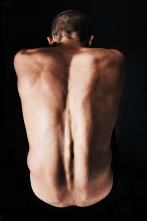 He just wants to be alone. Top view of a naked man curled into the fetal position.の写真素材