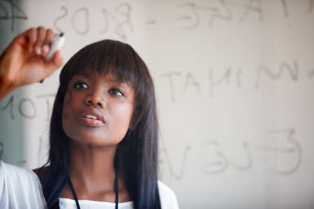 Planning it all out before starting. Cropped shot of a businesswoman doing planning on a glass wall.