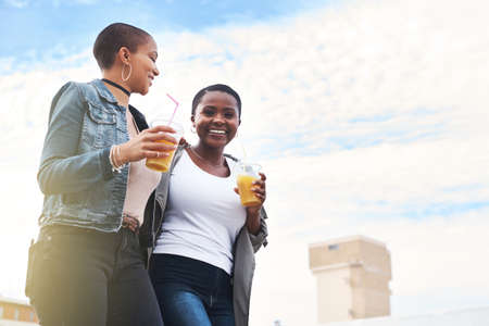 Always happier when Im with you. Low angle shot of two young women walking in the city laughing...
