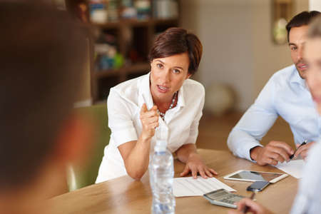 Consider this your final warning. Shot of a manager pointing angrily at an employee during a...