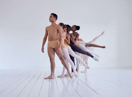 Bated breath at its finest. Shot of a group of ballet dancers practicing a routine in a dance...