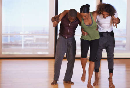 Friends and dance partners. Shot of a group of people practicing in a dance studio.の写真素材
