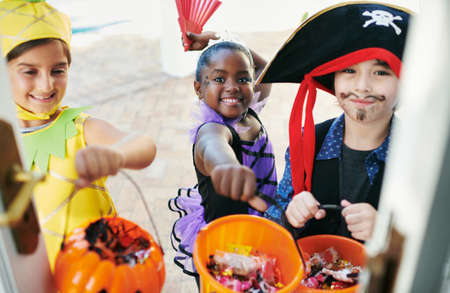 Candy time. Shot of a group of little children going trick-or-treating.の写真素材