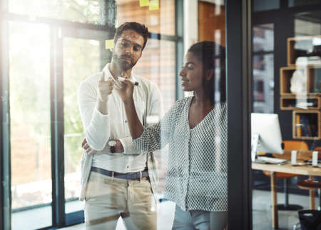 Pointing out the solution to the problem. Cropped shot of businesspeople discussing ideas.