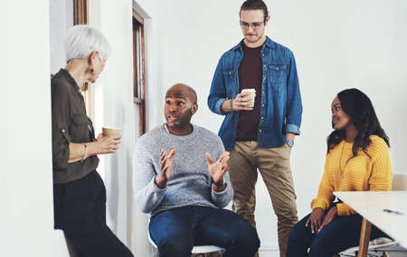 Always taking charge of the team. Cropped shot of a group of cheerful businesspeople having a...