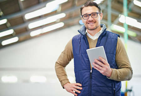 My little inventory friend. Portrait of a man with a digital tablet working in a distribution...