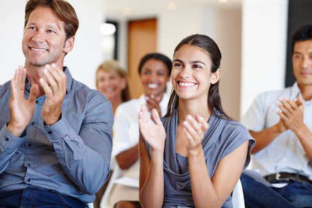 Showing their appreciation. Shot of a group of coworkers applauding a work seminar.
