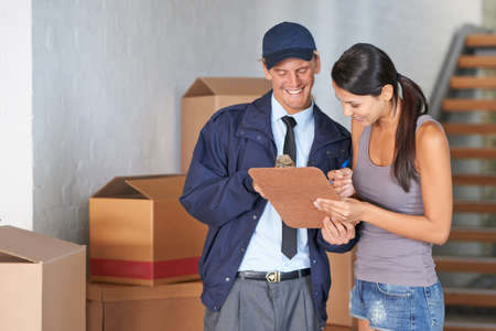 Finally her move was complete. Cropped shot of a beautiful woman receiving a delivery.