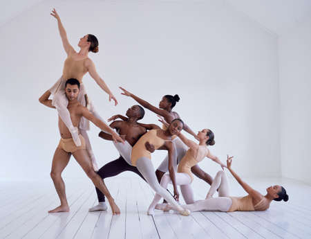 Perfectly positioned. Shot of a group of ballet dancers practicing a routine in a dance studio.の写真素材