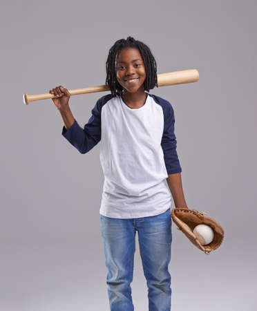 Ready to have a ball. Studio shot of a young boy with baseball gear.