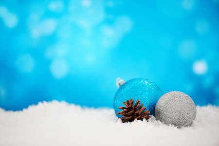 Christmas is better with glitter. An arrangement of Christmas decorations against a sparkly blue background.の写真素材