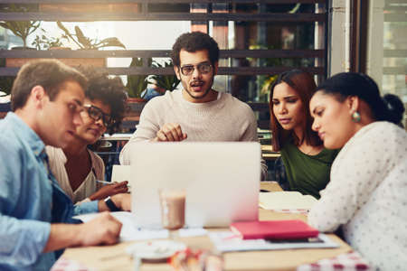 Lets see what we can do to improve the company. Cropped shot of designers having a meeting at a...
