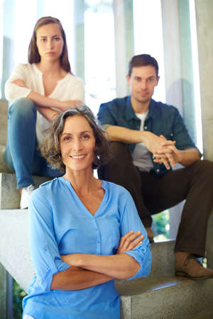 Theyre still my spring chickens. Shot of a mother standing in front of her adult children on the...
