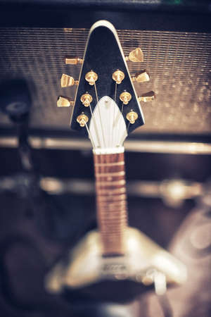 The guitar with the most sound. High angle view of a guitar leaning on an amp..