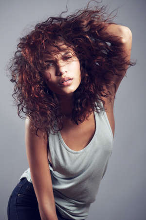 Shes got it. Studio shot of a gorgeous young woman posing against a gray background.
