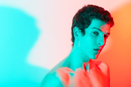 The beauty is in the concept of the colours. A male against a blue and red light looks at the camera...
