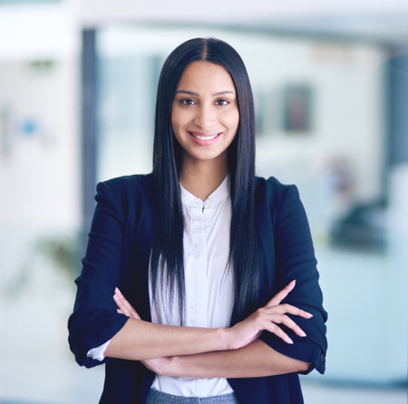 Business success starts with the boss. Portrait of a confident young businesswoman working in a modern office.の写真素材
