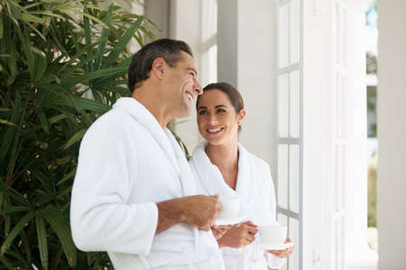Joy and relaxation at the day spa. Shot of a loving mature couple enjoying a cup of coffee at a day spa.の写真素材