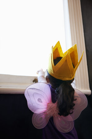 This little fairys got her sights set on the stars. Rearview shot of a little girl dressed up in her...