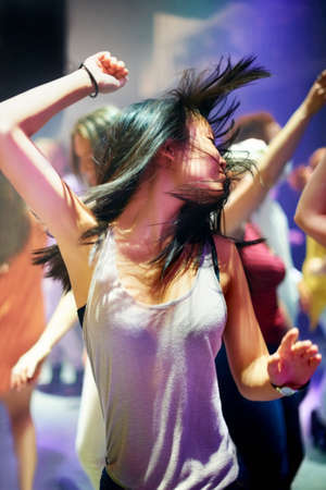 Shot of an attractive woman dancing to the music. This concert was created for the sole purpose of this photo shoot, featuring 300 models and 3 live bands. All people in this shoot are model released.の写真素材