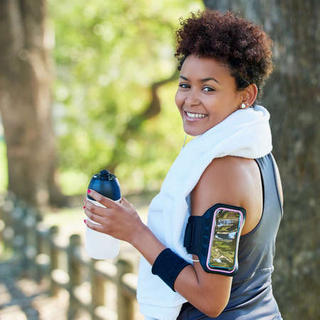 Dont forget to stay hydrated. Portrait of a sporty young woman out for a run.