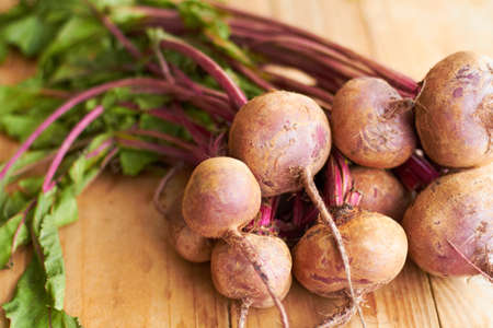 Good eats. Closeup shot a bunch of radishes on a cutting board.