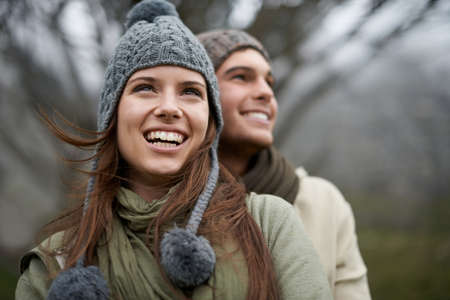They love taking in the mountain views. A happy young couple enjoying the sights while hiking...