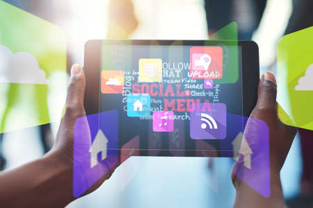 Connecting with the online world at work. Shot of an unrecognizable businesswoman using her digital...